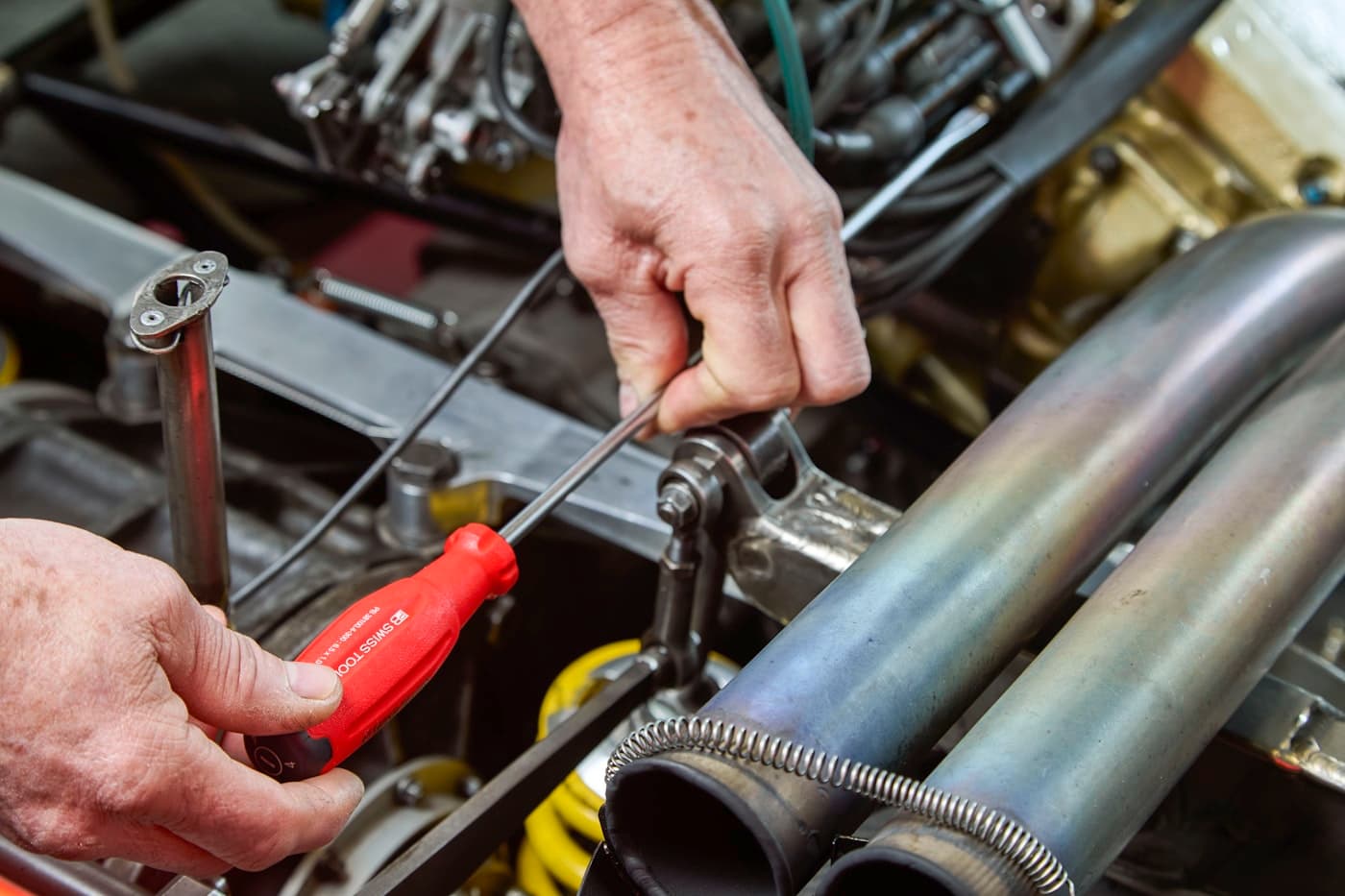 Mechanic working carefully on a vehicle engine bay