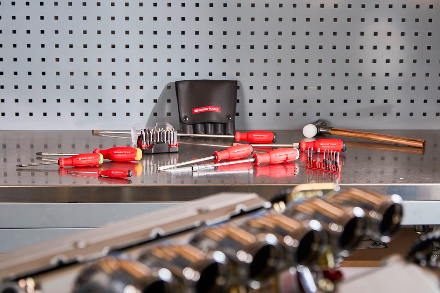 Organised screwdriver set and tools laid out on a clean workbench